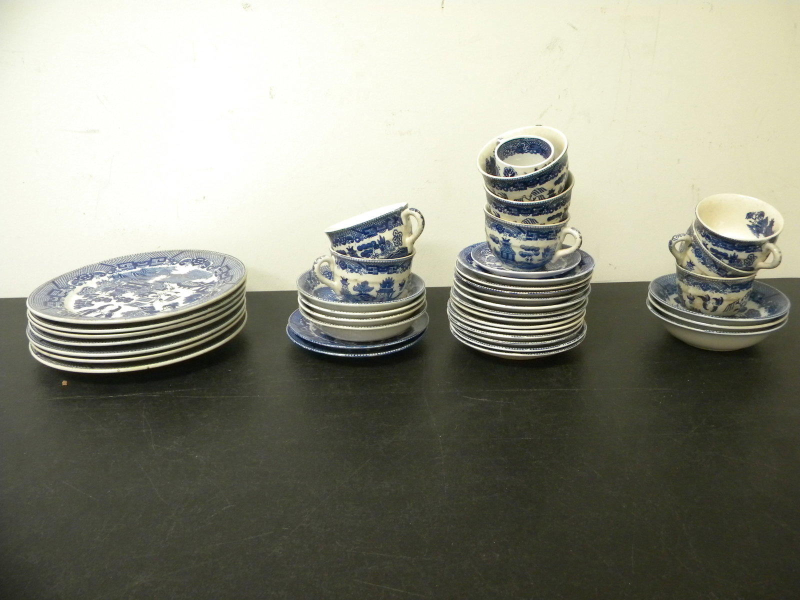 Blue Willow Grouping: plates and cups/saucers.