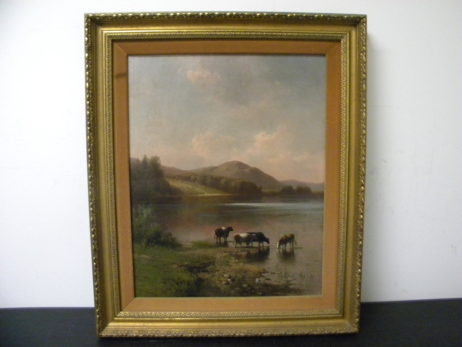 Oil on Canvas Hermann Gustav Simon: SLL, "H. Simon", dated 1883. Landscape painting of four cows around the river, with the mountain side in the background. Exposed 15"x19" and frame 21"x25".