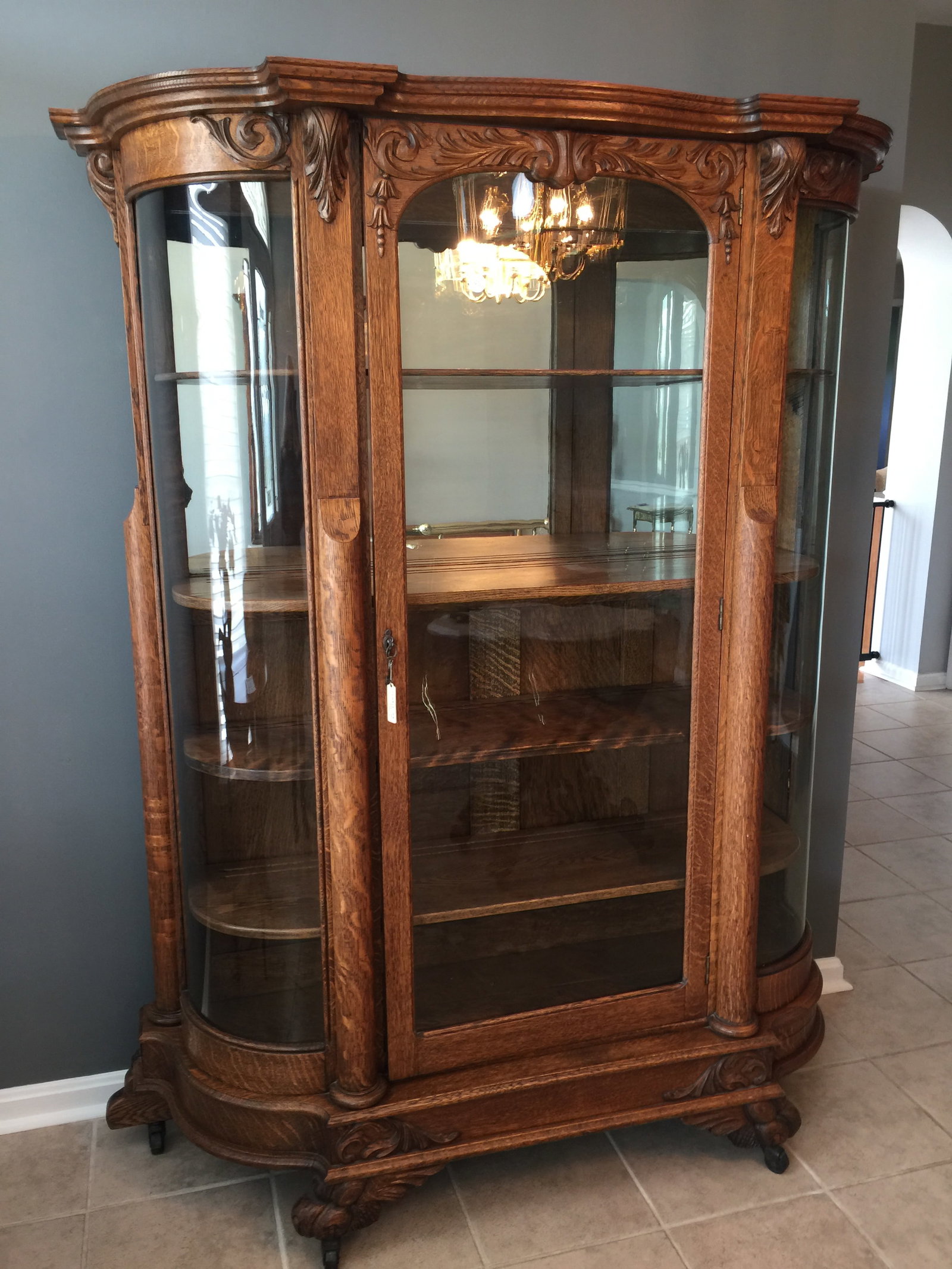 Ornate Carved Oak China Closet: applied carvings, lions paw carved feet, mirrored back, quarter sawn oak. 55"x18"x70".