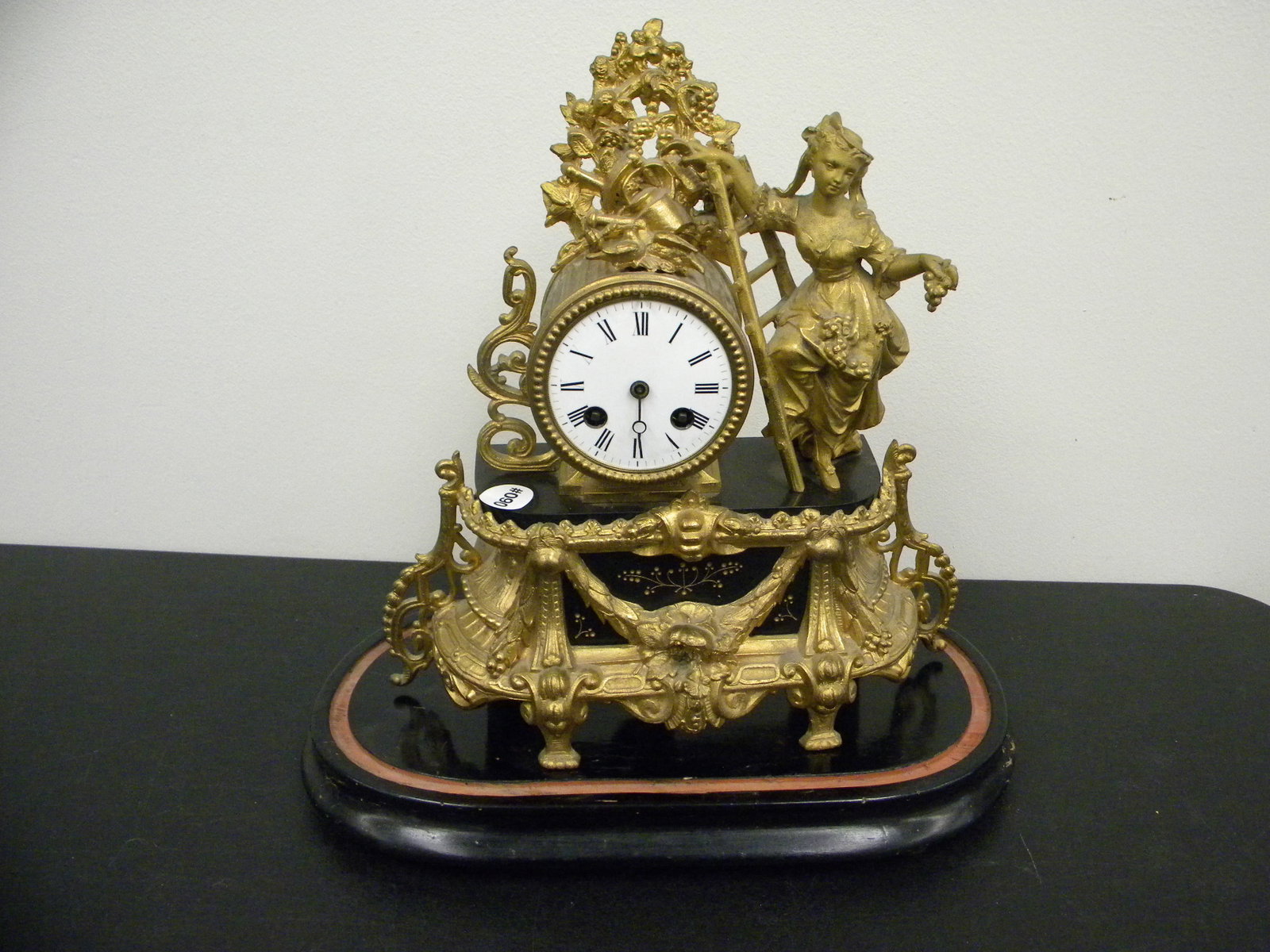 French Figural Clock: Works marked H.MCLLe Paris, Japy Freres. Clock 12" x 13", sits on wooden base.