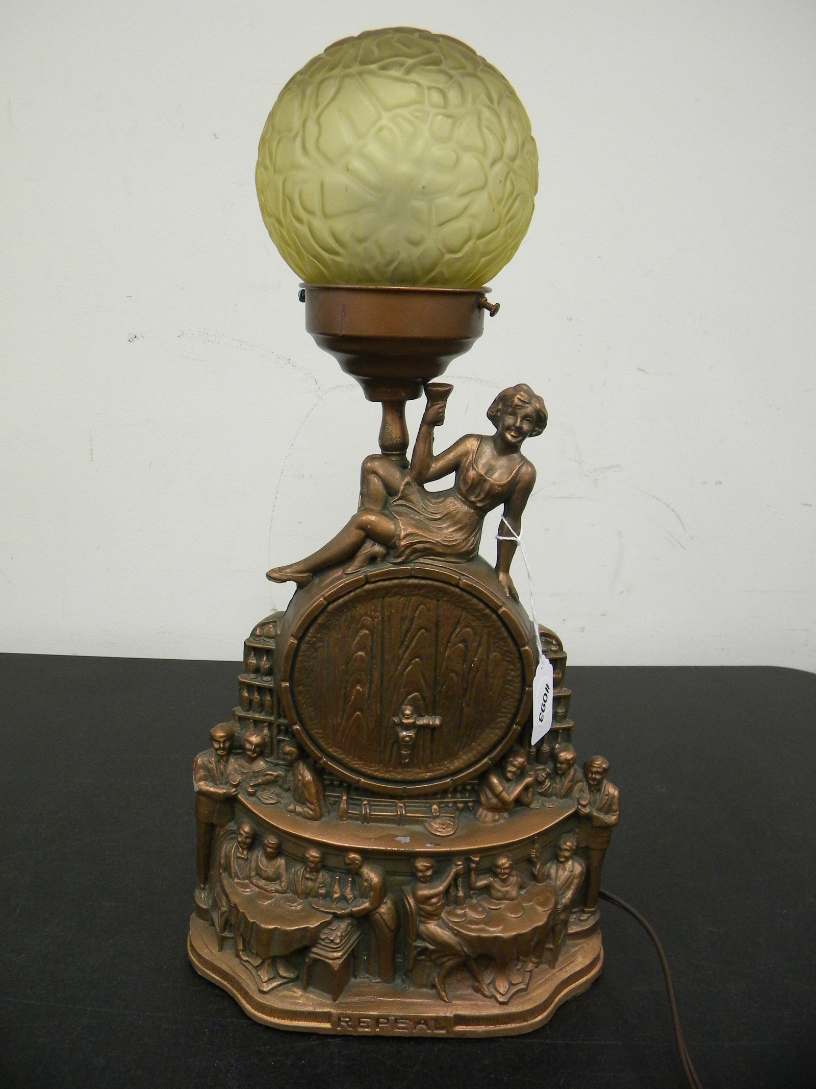 Art Deco Figural Lamp: Titled "Repeal". Cast metal body, 20" H to globe shade.