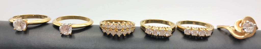 6-GOLD TONED BLING RINGS WITH CLEAR STONE: ACCENTS-NICE LOT!!!! VARIOUS SIZES (1)MARKED KOREA (1)MAKER CANNOT BE MADE OUT
