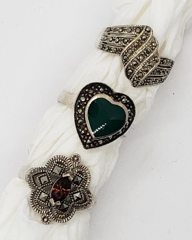 3-VITNAGE STERLING MARCASITE RINGS (1)W/: BURNT ORANGE CENTER STONE (1)GREEN INLAY STONE. VARIOUS SIZES 7.5-8.5. TOTAL 6.6 DWT