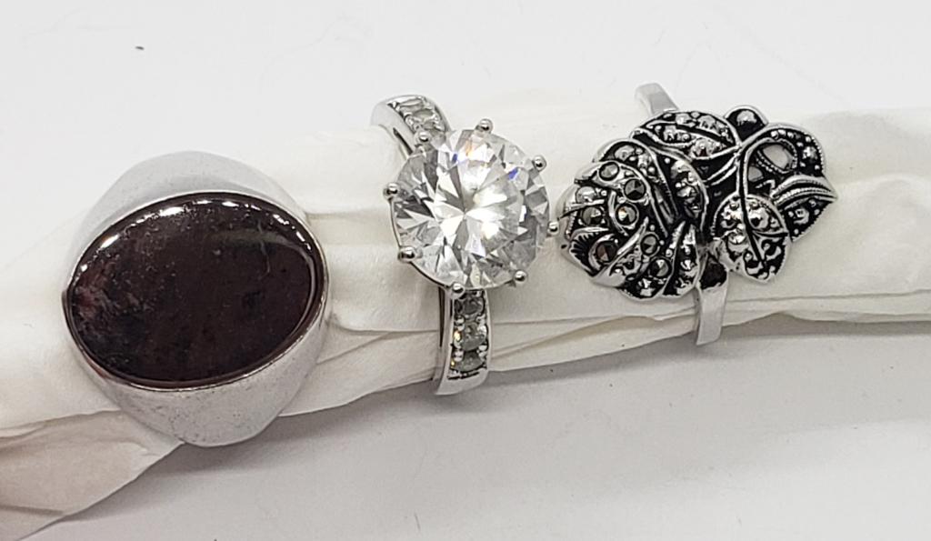 3-FASHION RINGS(2) STERLING: SIZE 11 BROWN STONE STERLING, SIZE 8 LARGE CLEAR STONE STERLING, SIZE 8 1/2 MARCASITE (NOT STERLING) - ( 11.7 DWT)