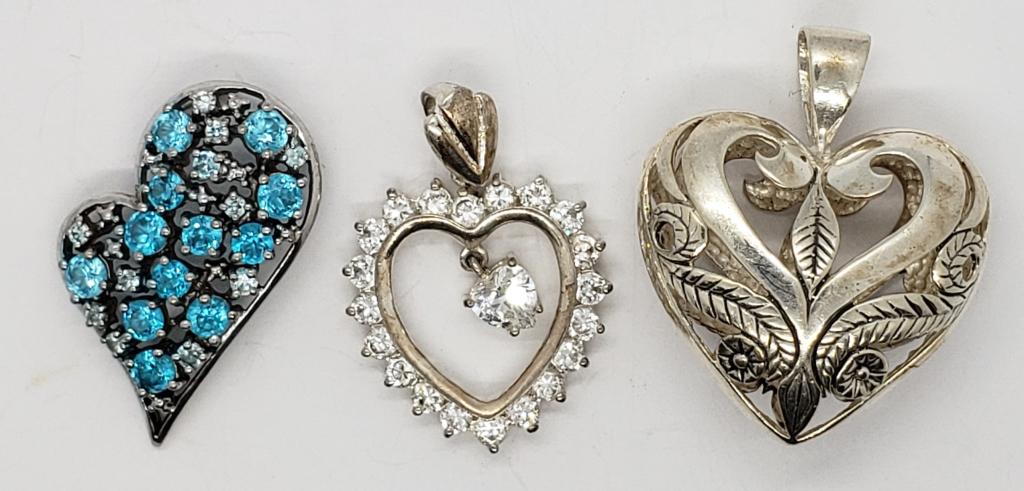 3-STERLING HEART PENDANTS: (1)BLUE STONES (1)FILIG: DESIGN (1)CLEAR STONE ACCENTS. NICE LOT!!! TOTAL 15.2 DWT