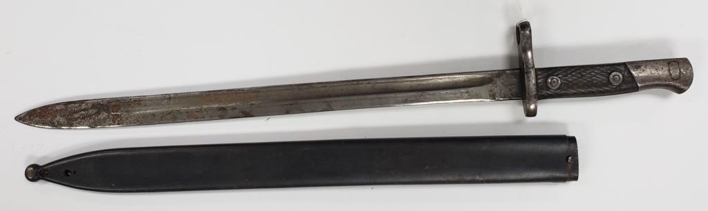 WWI Spanish Model Bayonet Artilleria National: Comes with scabbard. Scabbard has some holes drilled in it at the tip. Some surface rust is present on the blade and handle.