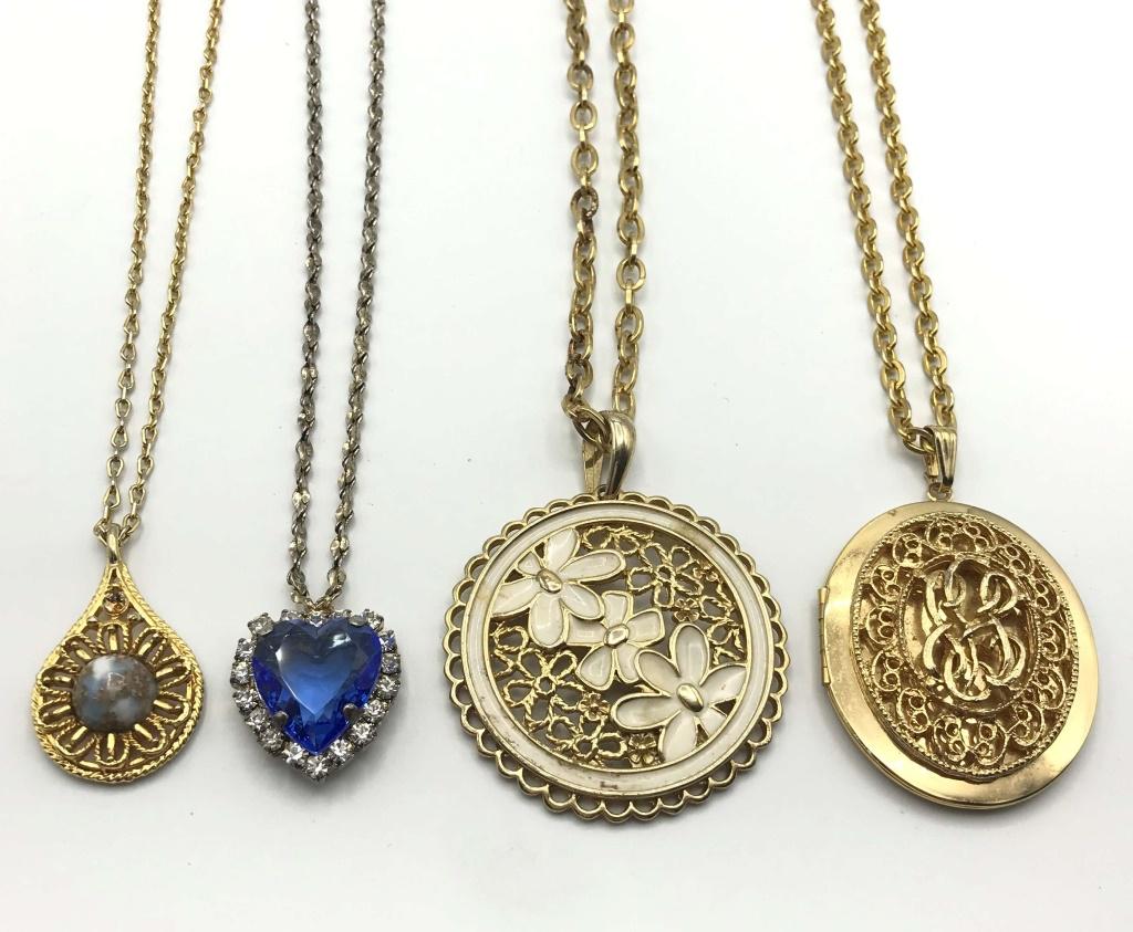 4-FASHION NECKLACES ALL WITH GORGEOUD PENDANTS: (1)SILVER TONED WITH RHIINESTONE HEART MARKED 1998 BC LIND (1)CIRCULAR FLOWER PENDANT WITH ENAMEL (1)TEARDROP PENDANT WITH BLUE MARBLE LUCITE CENTER & (1)LOCKET NECKLACE. NICE LOT!!