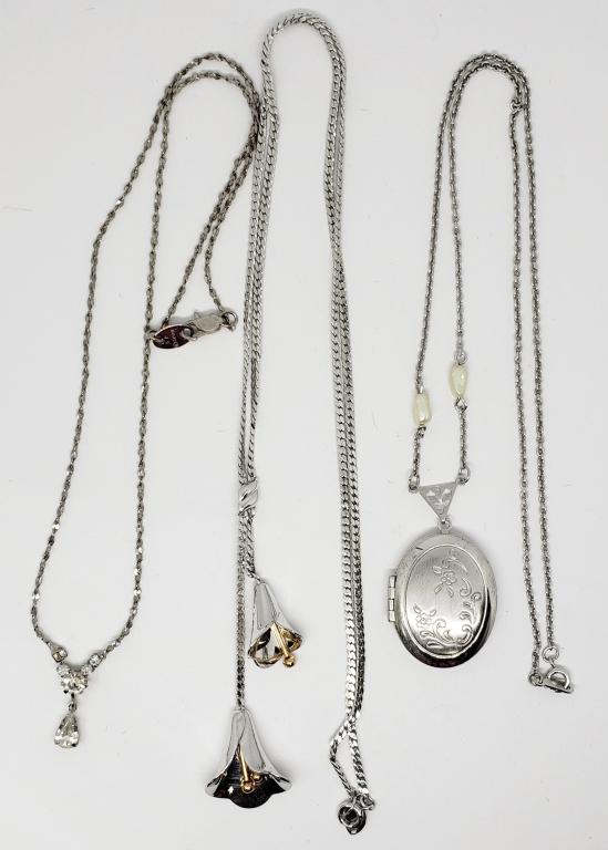 3-VINTAGE SILVER TONED NECKLACES: (1)AVON: CALA LILLY (1)AVON WITH RHINESTONE ACCENTS (1)AVON LOCKET WITH FRESHWATER PEARL ACCENTS