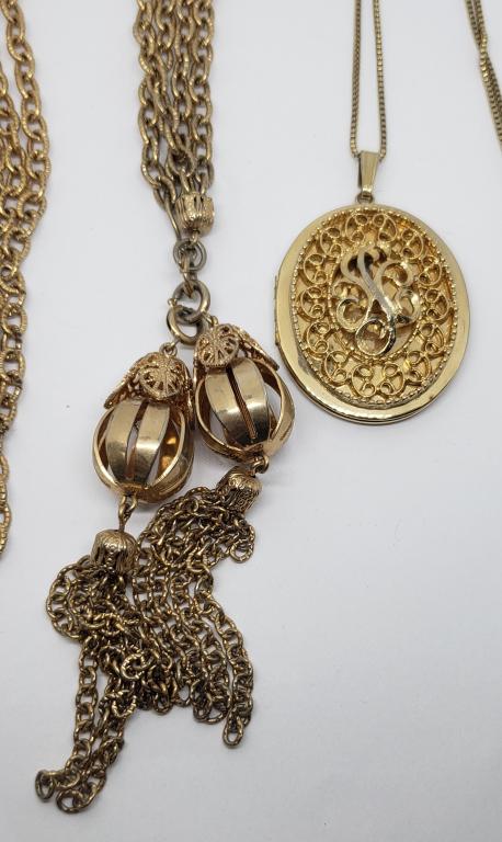 2-VINTAGE GOLD TONED NECKLACES: (1)LOCKET PENDNAT: (1)WITH MULTI CHAIN AND DANGLY CHARMS