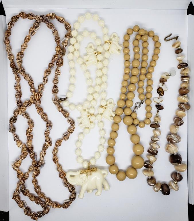 4-VINTAGE BEADED NECKLACE: (1)ELEPHANT CHARM: (1)SEASHELL (1)POLISHED NATURAL STONE (1)TAN