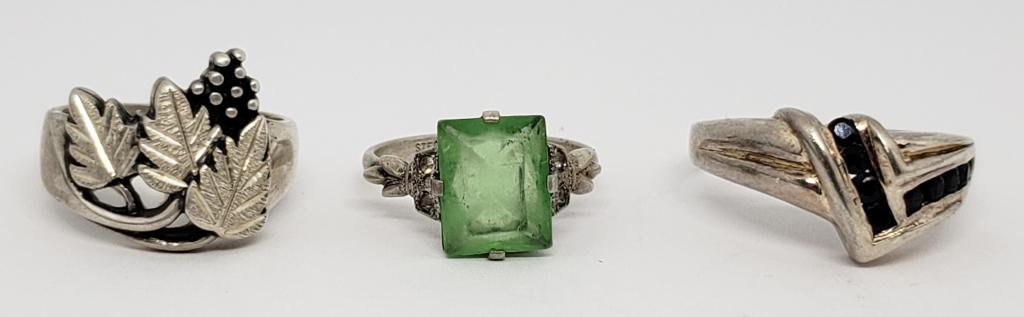 3-STERLING RINGS: (1)GREEN STONE WITH MARCASITE: EDGES (1)LEAF DESIGN (1)WITH MULTIPLE NAVY BLUE COLORED STONES-VARIOUS SIZES 6-9-TOTAL 7.4 DWT
