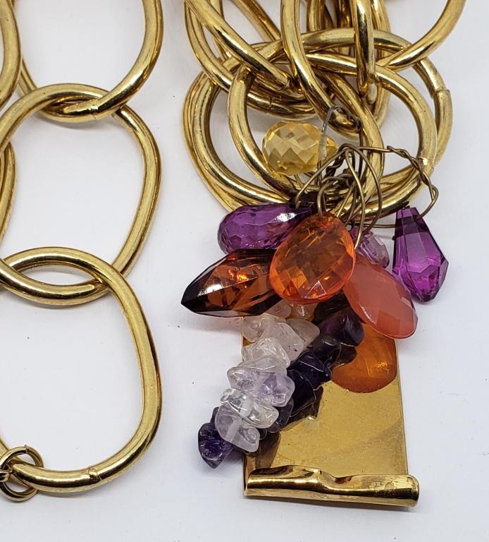 CHUNKY IMAN LINKED NECKLACE WITH AMETHYST: AND LUCITE DANDLY CHARMS ON SQUARE GOLD TONED PENDANT