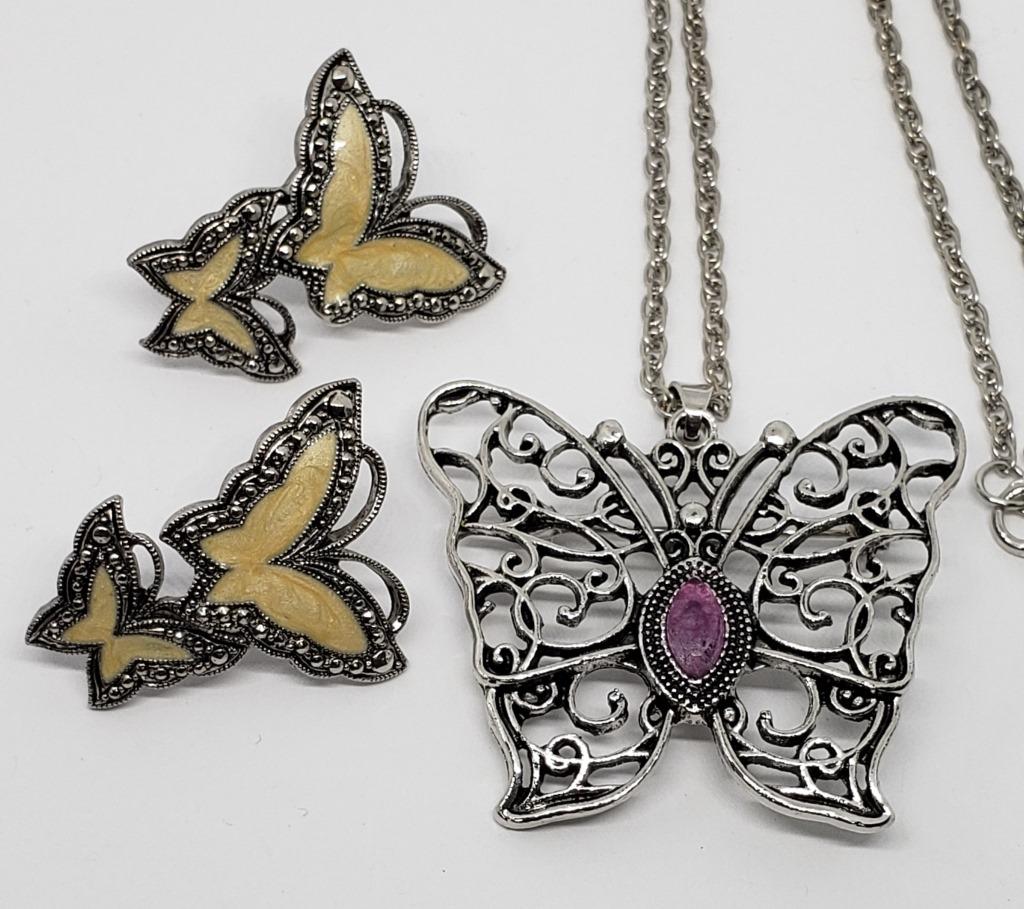 SILVER TONED BUTTERFLY JEWELRY: (1)PAIR OF: PIERCED MARCASITE EARRINGS WITH ENAMEL & (1)NECKLACE WITH FILIGREE WINGS AND PURPLE LUCITE CENTER