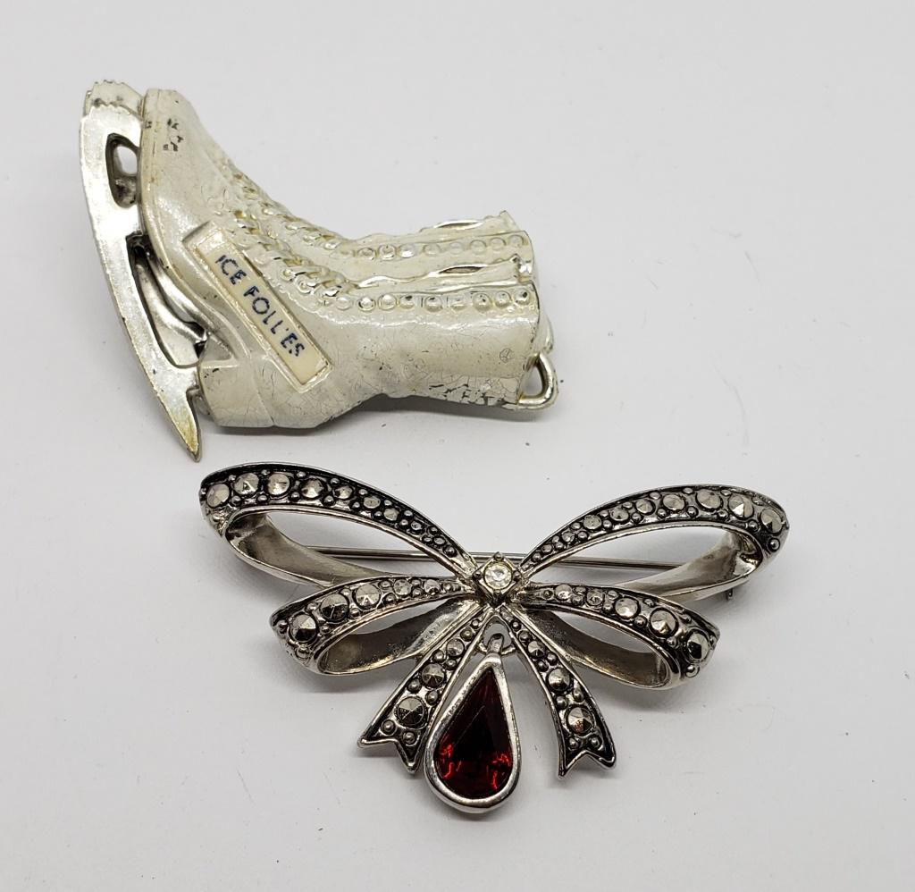 2-VINTAGE SILVER TONED CHRISTMAS BROOCHES: (1)ICE SKATES (1)MARCASITE BOX WITH RED RHINESTONE CHARM