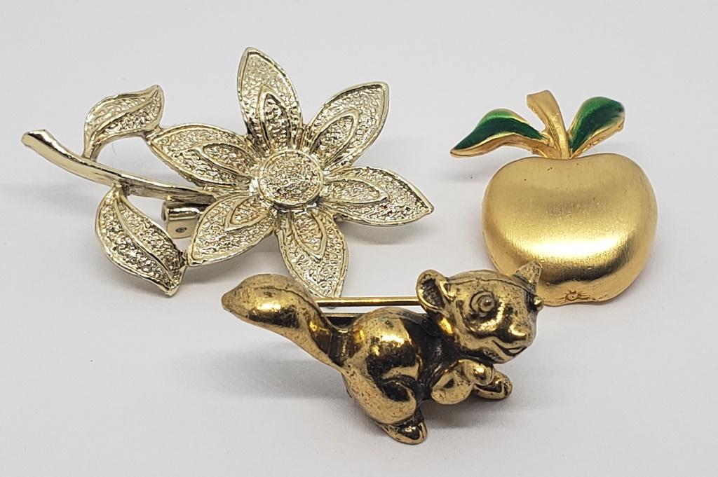 3-GOLD TONED BROOCHES/PINS (1)APPLE WITH: GREEN ENAMEL (1)ZENTALL SQUIRREL (1)GERRY'S FLOWER