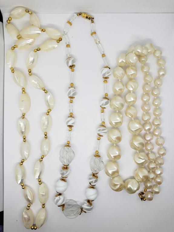 3-VINTAGE BEADED NECKLACES: (1)TRIAFARI OFF: WHITE LUCITE (1)SHELL (1)CLEAR AND WHITE GLASS
