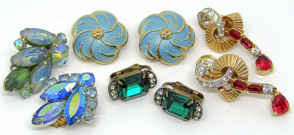 4-PAIRS OF VTG CLIP ON EARRINGS: (1)WEISS WITH: EMRALD GREEN AND CLEAR RHINESTONES (1)MAZER WITH RUBY RED AND CLEAR RHINESTONES (1)MARVELLA FLOWER WITH BABY BLUE ENAMEL (1)CORO WITH BABY BLUE RHINESTONES AND LUCITE