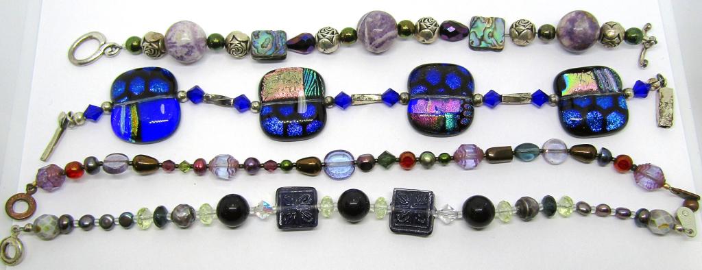 4-SILVER TONED GLASS BEADED BRACELETS: MULTIPLE DIFFERENT COLORS