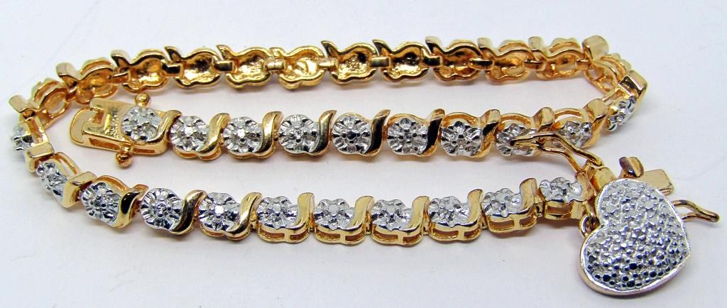 STERLING GOLD TONED TENNIS BRACELET WITH: CLEAR STONES-WITH A HEART CHARM-7.5 INCHES LONG-TOTAL 6.6 DWT