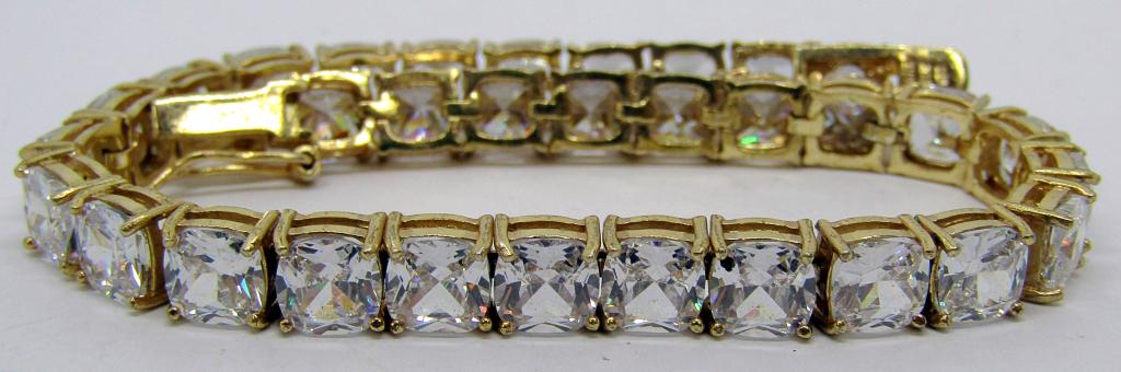 GOLD TONED STERLING TENNIS BRACELET WITH: LARGE SQUARE CLEAR STONES-TOTAL 16 DWT