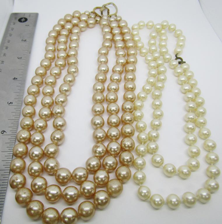 FAUX PEARL NECKLACES: 1-LONG CREAM COLORED FAUX PEARL NECKLACE W/ BRONZE TONED CLASP 1- THREE-TIERED FAUX PEARL NECKLACE W/ GOLD TONED CLASP