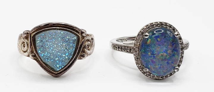 2-STERLING FASHION RINGS: (1)SAJEN WITH BABY: BLUE DRUZY STONE (1)WITH OPAL-LIKE CENTER STONE-CLEAR BORDER DESIGN-BOTH RINGS SIZE 7-TOTAL 5 DWT