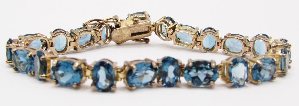 7 INCH STERLING GOLD TONED TENNIS BRACELET: WITH TEAL STONES-TOTAL 10 DWT