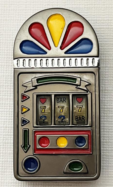 Casino Theme Collectible Lighter: Casino slot machine theme. Lights up when lid is open. Marked 'NUGGET' on top.