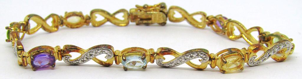 7.5 GOLD TONED STERLING TENNIS BRACELET: INFINITI DESIGN WITH MULTI COLORED STONES-TOTAL 6 DWT
