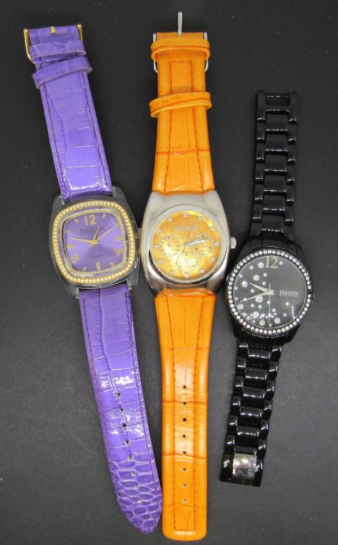 3 Joan River Classic Womens Quartz Watches: Not tested as to working or not-some for parts or repair-some may work-Joan River Classic Womens Quartz Wrist Watches (1)orange leather band (1) purple leather band (1) JR classic black steel link ban
