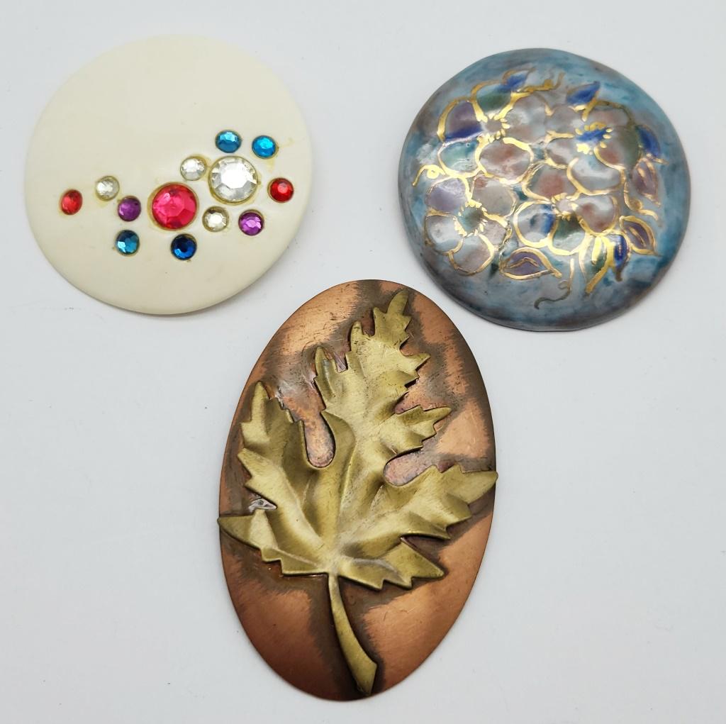 3-VINTAGE BROOCHES (2)COPPER TONED: (1)CRÈME LUCITE WITH RHINESTONES