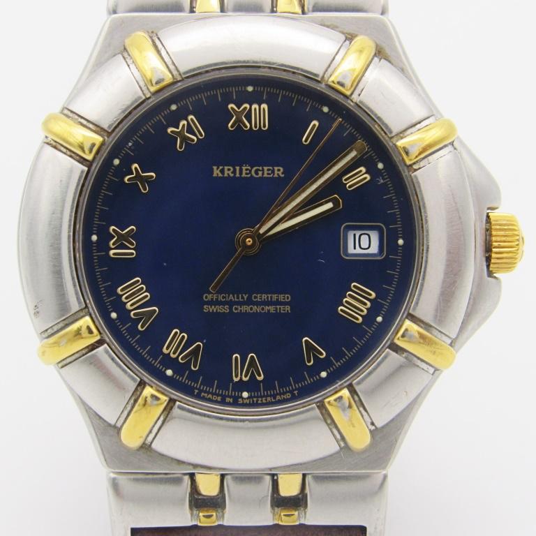Gents Krieger Quartz Watch: Stainless steel screwback case. Officially certified chronometer quartz movement. Stainless deployment buckle. Circ 1997 with a new strap. Complete with all books, boxes, and warranty card.