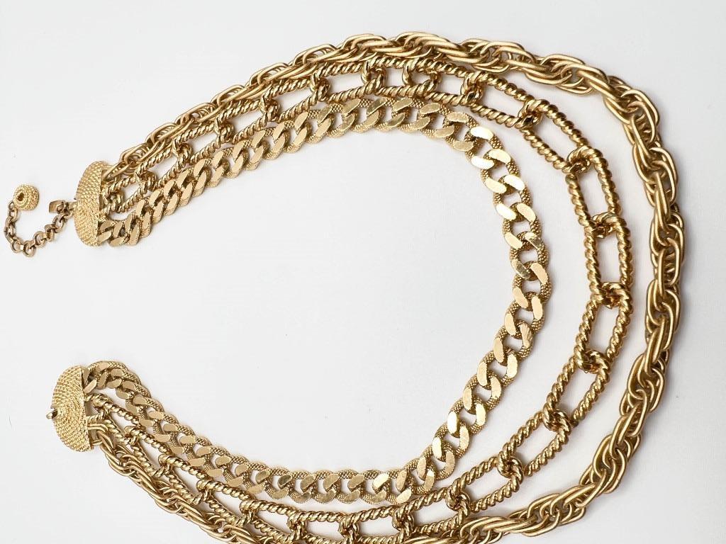 MONET SIGNED TRIPLE STRAND: MONERT SIGNED TRIPLE STRAND GOLD TONE NECKLACE