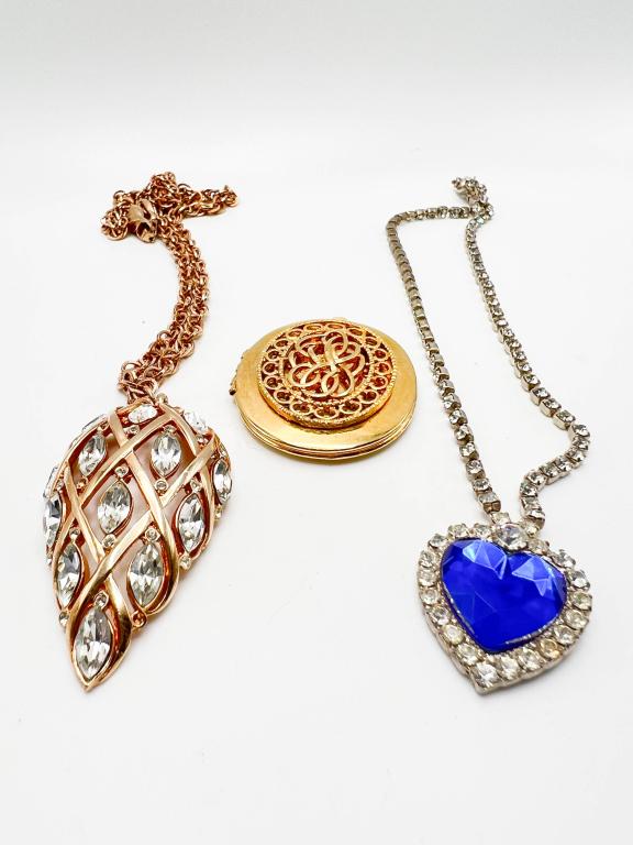 FABULOUS NECKLACES: FABULOUS NECKLACES , WHITE STONES INTERTWINED WITH GOLD TONE , CIRCLE LOCKET, BLUE STONE SURROUNED BY WHITE STONE NECKLACE IN SILVERTONES