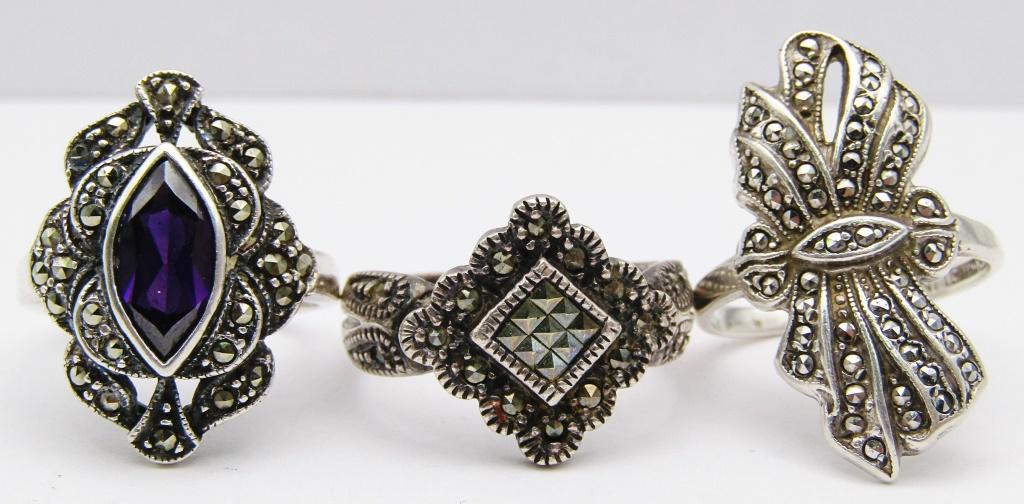3-VINTAGE STERLING MARCASITE RINGS (1)WITH: PURPLE CENTER STONE-VARIOUS SIZES 7-8-TOTAL 10 DWT