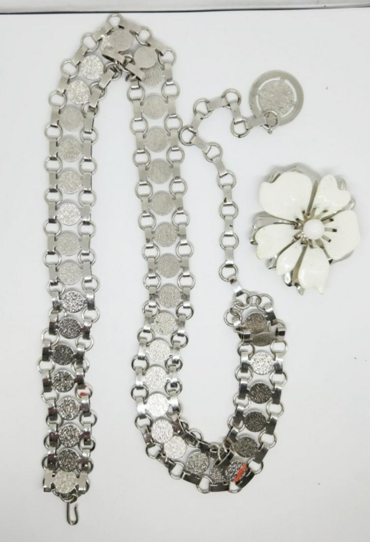 VINTAGE SARAH COVENTRY SILVER TONED JEWELRY: LOT: (1)30 INCH NECKLACE WITH RHINESTONE PENDANT (1)METAL FLOWER BROOCH WITH WHITE ENAMEL & (1)34 INCH FASHION BELT