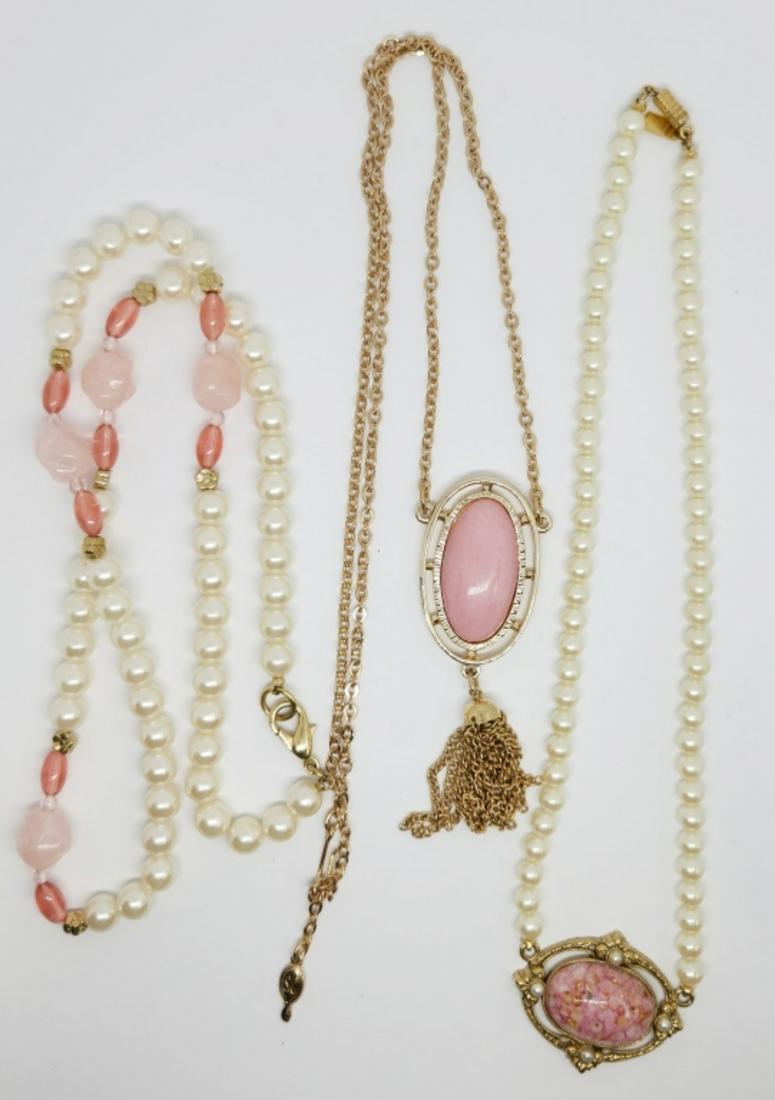 3-VINTAGE GOLD TONED NECKLACES WITH PINK: LUCITE ACCENTS: (1)17 INCH 1928 FAUX PEARL (1)20 INCH SARAH COVENTRY WITH TASSLE & (1)24 INCH FAUX PEARL BEADED