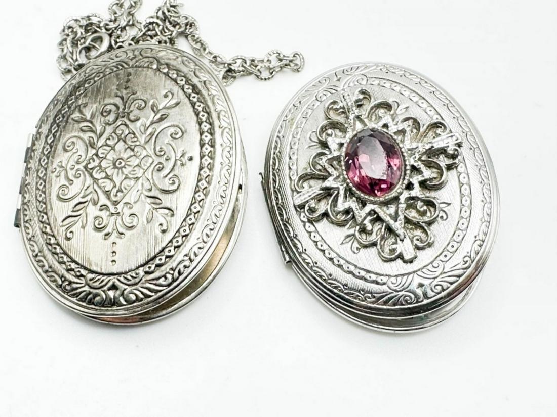 2 SILVERTONE LOCKETS: 2 SILVERTONE SCROLL LOCKETS, ONE WITH AMETHSYT COLOR STONE