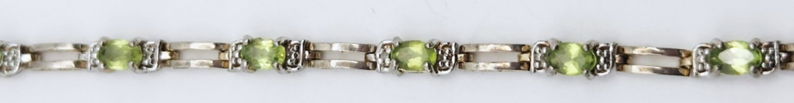 STERLING GOLD TONED TENNIS BRACELET WITH PERIDOT: STONE ACCENTS-MEASURES 7.5 INCHES-TOTAL 7 DWT