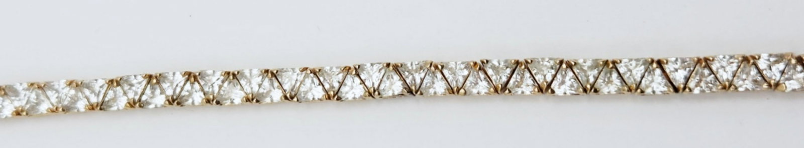 STERLING GOLD TONED TENNIS BRACELET WITH: TRIANGULAR CZ DESIGN-MEASURES 8.5-TOTAL 13 DWT