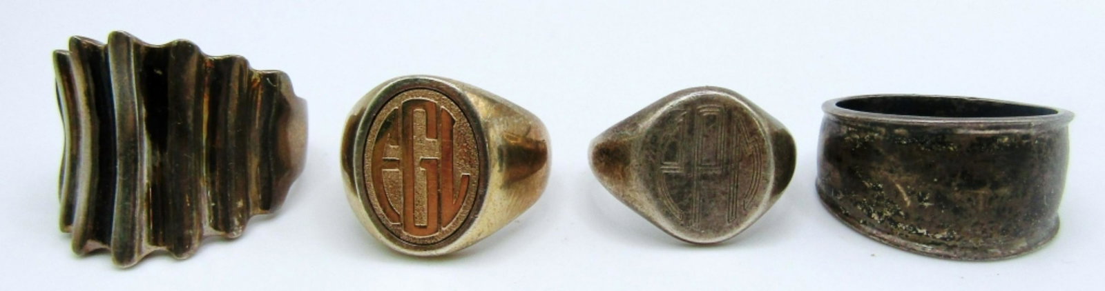 (4) Sterling Rings: 23.6dwt, sizes from 7 1/2 to11, all marked 925 inside ring, one ring has gold plate of 14k with EGL engraved on front, another has EPM in middle.