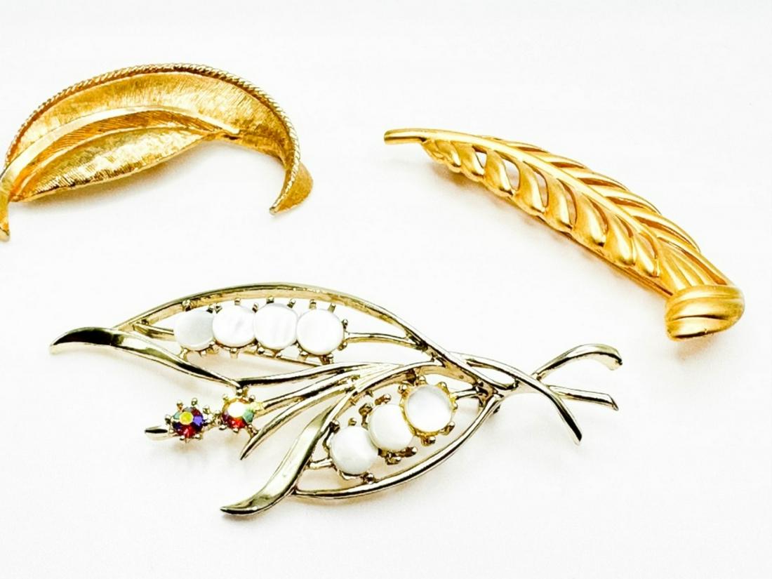 3 LEAF BROOCHES: 3 LEAF BROOCHES 2 ALL GOLD TONE, 1 GOLD TONE WITH MOTHER OF PEARL AND COLORED STONES ATTACHED