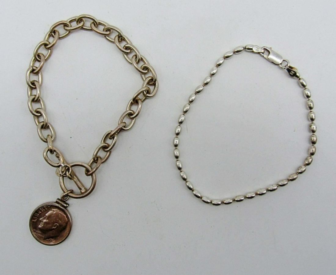 925 Coin Bracelet & Dainty 925 Bracelet: 17dwt, 8in in length a dime for a charm, stamped made in u.s.a 925 The American Historic Society with a toggle clasp, second bracelet simple danty 8in staped 925