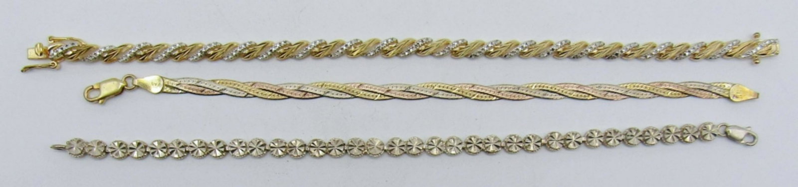 (3) Sterling Bracelets: 12dwt,7in a tri color bracelet with lobster clasp stamped 925 made in italy, 7 1/2 in sterling circle design stamped 925, 8in gold filled with clear stones tennis bracelets stamped made in china 925