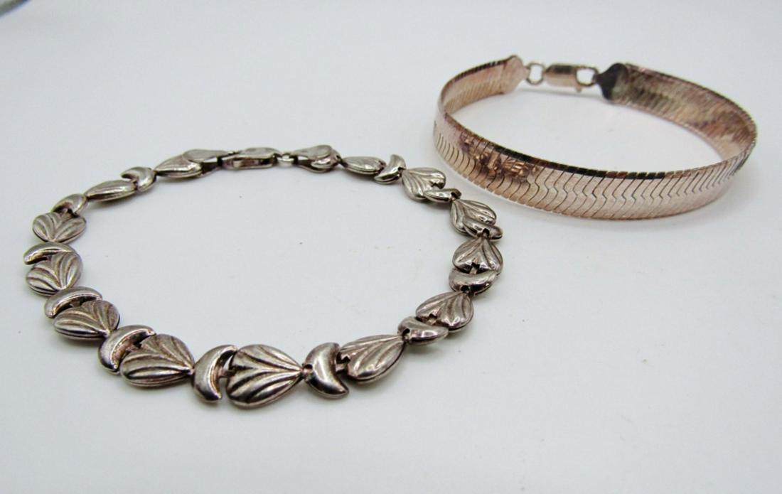 (2) Sterling Bracelets: 13.4dwt, 7in in length for Herringbone style stamped 925 on lobster clasp, 7 1/2 in for the cresent moon and heart bracelet stamped italy 925 on lobster clasp