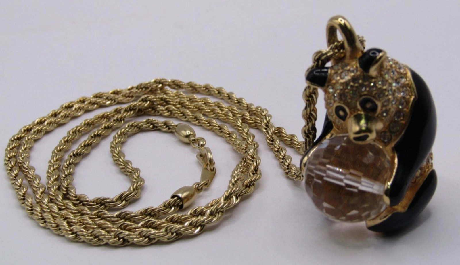 VINTAGE SWAROVSKI PANDA HOLDING CRYSTAL BALL PENDA: VINTAGE SWAROVSKI PANDA HOLDING CRYSTAL BALL PENDANT GOLD TONE WITH TWIST GOLD TONE CHAIN. MISSING STONE ON BACK.