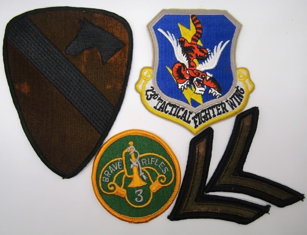 (5) MILITARY PATCHES: 23RD TACTICAL FIGHTER WING FLYING TIGER, BRAVE RIFLES 3, (2) SINGLE CHEVRONS, ARMY FIRST CALVARY.