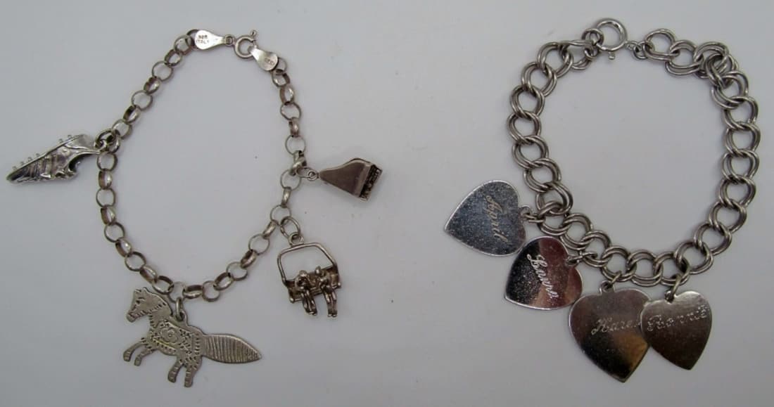 (2) Sterling Charm Bracelets: both are 7in in length, one has 4 heart charms with names on front and dates on the back all charms are marked sterling and bracelets as well, second charms are a cleat, a donkey, ski lift and a piano