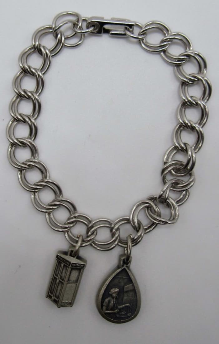 Sterling Charm Bracelet: 7in bracelet marked sterling, Two charms both say sterling made by ATTENDANCE ,14 DWT