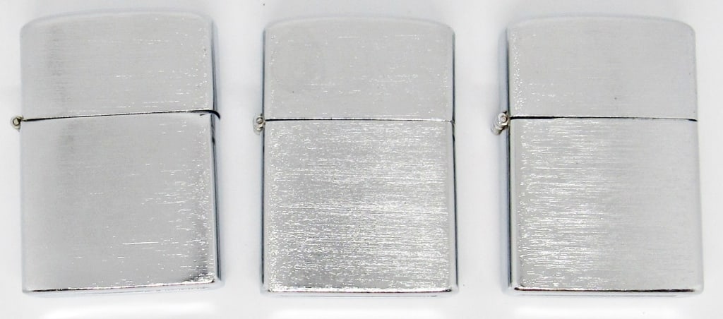 (3) SILVER TONED LIGHTERS made in JAPAN: LIKE NEW - (1) LOOKS STRUCK - UNTESTED